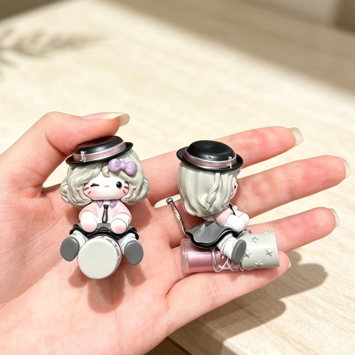 Pastel seated hat girl decorative dolls held in one hand