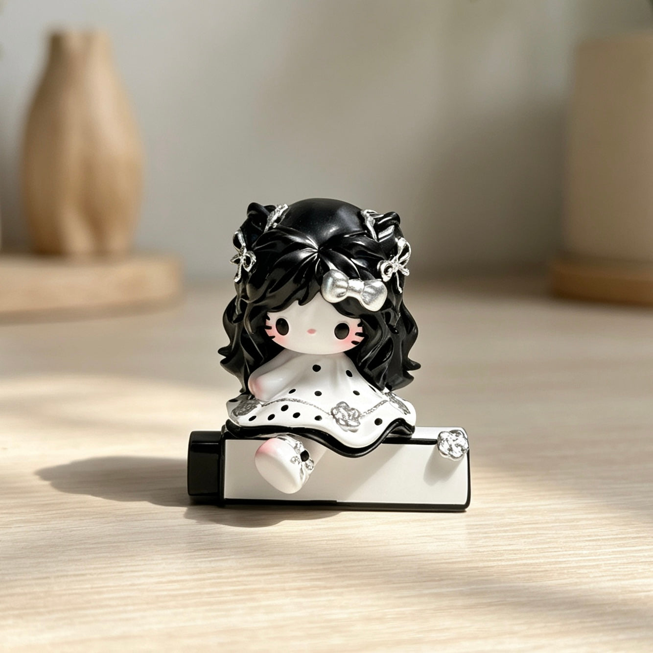Black-and-white decorative doll figure on decorative tube